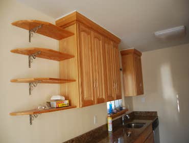 kitchen Kitchen remodel including cabinets, counters, custom shelves, and flooring and custom stairs