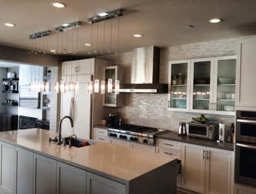 Photos by The Tradesman Electric #1 Install two custom wall sconces and add four LED can lights to the soffit area.