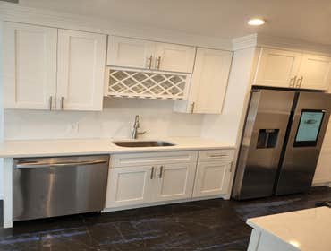 Kitchen Remodel Reconfigured space with new hardwood shaker cabinets with Quartz countertops.
