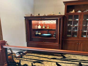 TV armoire converted into Wet Bar This was TV armoire that the customer wanted converted into a wet bar. We built a custom insert to accommodate a rack