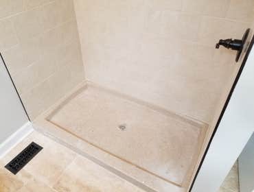 Onyx shower pan with tile walls