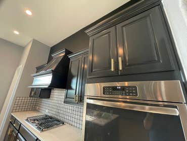 Photos by Austin Fine Finish Painting LLC #1 46 Piece Cabinet repaint. Benjamin Moore Satin Impervo color matched to SW Tricorn Black. Photos taken d