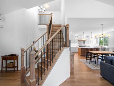 Photos by Vmr Custom LLC #1 Custom staircase and flooring installation featuring natural white oak treads, custom wood newel posts, and black metal bal