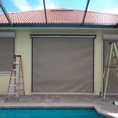 Electric Hurricane Screens Electric Hurricane Roll-up Screen covering rear lanai area. Great product for hurricanes, sun protection, keeping lanai's dr