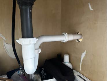 Photos by Des in the Cut Construction Company #1 We replaced a plastic, double-sink drain with pvc pipes, two P-traps and installed a vent so the water