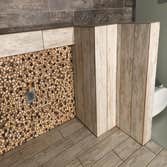 Shower remodel Wood plank porcelain tile with glass mosaic shampoo box, and stone floor. All bull nosing done by hand.