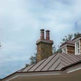 European Copper Pots on 5 chimneys. We designed, fabricated and installed custom copper flashing with 7 European Copper Pots for a luxury residence in 