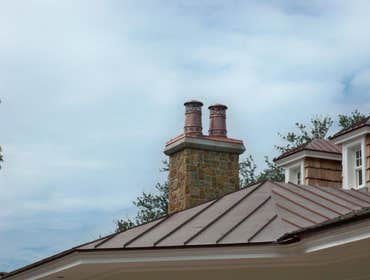 European Copper Pots on 5 chimneys. We designed, fabricated and installed custom copper flashing with 7 European Copper Pots for a luxury residence in 