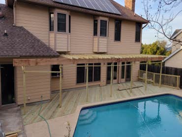 Photos by Rojas Acquisitions LLC #2 Demo out rotted deck and porch, framed in New subfloor and stabilized each rafter, all new pressure treated from fl