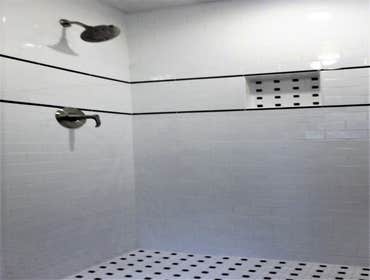 Photos by Cornerstone & Son Construction LLC #1 Shower stall remodeled with subway tile, black & white mosaic tile, black accents and recessed shampoo 
