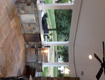 Outdoor kitchen/ sitting area This was a outdoor pavillion on the back of the homeowners house with a grilling area a fire place and outdoor sitting ar