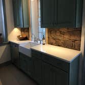farm sink with stone wall