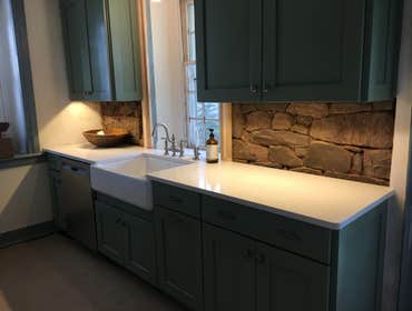 farm sink with stone wall
