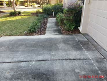 Photos from Popa Construction LLC Before & Afters of a soft wash roof cleaning and driveway and side walk cleaning.