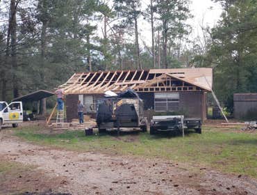 Photos by Service Restoration Pros LLC #1 A tree fell through the roof of this 3 bedroom house during Hurricane Ida. It left several gaping holes and a