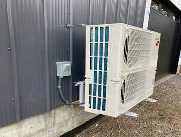 Mini Spit outdoor unit on a hanger