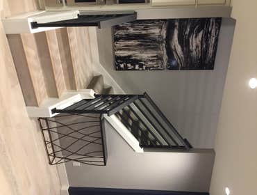 METAL RAILING BEING CAPPED WITH HARD MAPLE WITH STAIN CLIENTS WERE LOOKING FOR A MODERN LOOK TO THEIR METAL HAND RAIL WITH A WOOD ASCENT. THIS WAS A CU