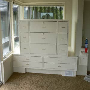Custom jewelry box cabinet This jewelry cabinet was designed by us and built on site. The two large center drawers are lockable, while the outer...