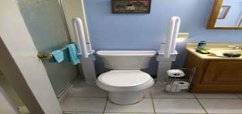 Photos by Get A Grip Bath Safety #2 Health Craft folding rails with up rite base mounted in concrete slab with ceramic tile.