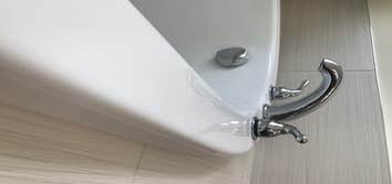 Bathtub Repair The homeowner chose to relocate plumbing fixtures - Original installation holes were properly supported and the repair area was refinish