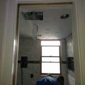 New Granite Bathroom Gutter out full bathroom, Re-Direct toilet and stand up shower... install new housing light new electrical new plumbing, new heati