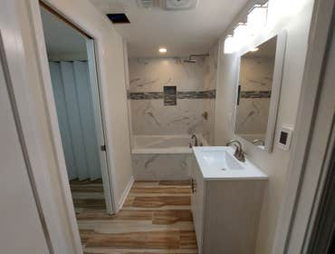 Photos by M&c Global Construction LLC #1 This Severn, MD, project combined a bathroom remodel with heated tile floors and a jacuzzi tub, and a laundry 