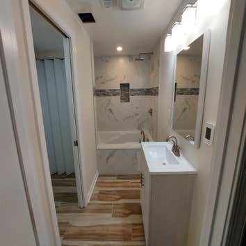 Photos by M&c Global Construction LLC #1 This Severn, MD, project combined a bathroom remodel with heated tile floors and a jacuzzi tub, and a laundry 