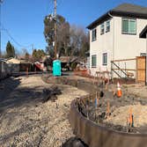 Curbaril Project A four home development. Installed foundations, site fencing, curbs, and driveways.
