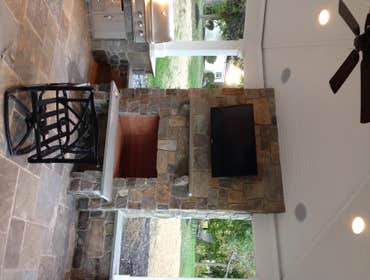 Outdoor kitchen/ sitting area This was a outdoor pavillion on the back of the homeowners house with a grilling area a fire place and outdoor sitting ar
