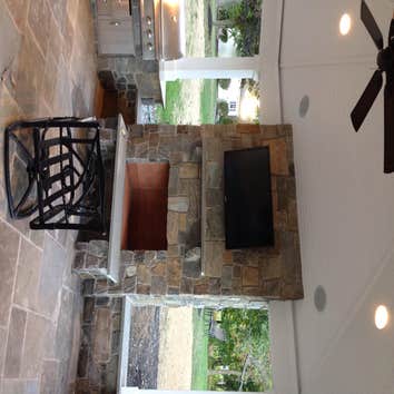 Outdoor kitchen/ sitting area This was a outdoor pavillion on the back of the homeowners house with a grilling area a fire place and outdoor sitting ar