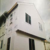 Project photos from Desrochers Construction Removed existing two story rear porches and build three bedroom addition. Install new white vinyl siding