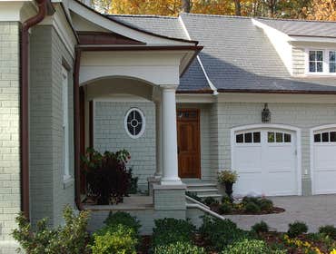 Carriage style doors First door (white with black hardware) is a stamped steel entry level door, second white painted custom door from Carriage House D