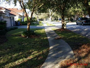 Photos from Popa Construction LLC Before & Afters of a soft wash roof cleaning and driveway and side walk cleaning.