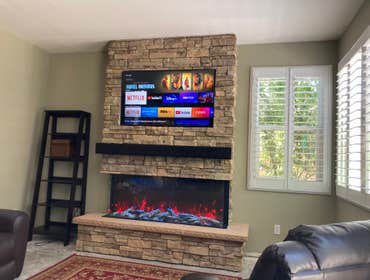 New Fireplace Remove old mantle and frame stone for a new fireplace. Also added electrical, and new 3 sided fireplace.