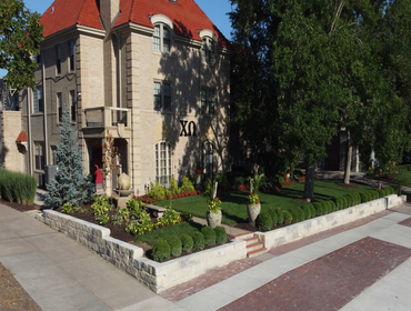 Chi Omega Retaining Wall – Lincoln, NE Installation of 3’ tall engineered retaining wall with proper drainage, footings, and finished landscaping. Scop