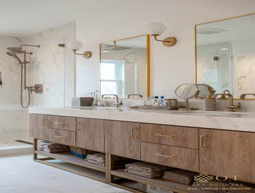 Photos by O.T Bay Builders- Master Bathroom with Tub and walk in shower This bathroom remodel showcases a marble privacy wall for the stand-alone tub a