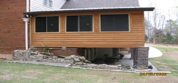 Photo(s) from Home Renovations & Remodeling Wall of windows great room addition, deck & cypress porch with stone water fall, pond & patio