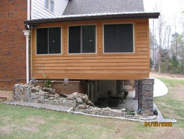 Photo(s) from Home Renovations & Remodeling Wall of windows great room addition, deck & cypress porch with stone water fall, pond & patio