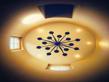 Photos by The Tradesman Electric #1 Install two custom wall sconces and add four LED can lights to the soffit area.
