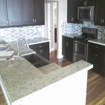 Granite with glass backsplash.