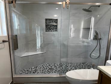 Project 522 Renovation of 2 full baths including materials and modification of exterior door to a full wall and a window
