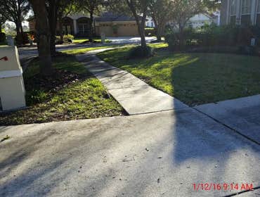 Photos from Popa Construction LLC Before & Afters of a soft wash roof cleaning and driveway and side walk cleaning.