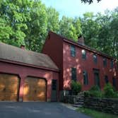 Mansfield Farmhouse This beautiful rustic farmhouse needed some minor repairs and a new attic vent installed before being primed and painted with our W