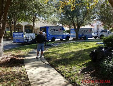 Photos from Popa Construction LLC Before & Afters of a soft wash roof cleaning and driveway and side walk cleaning.