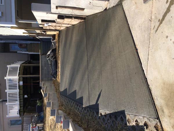 Concrete driveway with block retaining wall