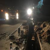 TAPPING MAIN & WATER LINE INSTALLATION Hot Tapping a 10 inch Water Main, Running 300 ft of 2inch water supply with back flow preventer