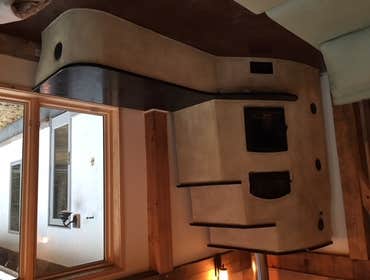 Photos by Grz LLC #3 Masonry Heater - Stucco & Soapstone
This custom built masonry heater, burns one load of wood (approx. 45 lbs.) every 12 hours to h