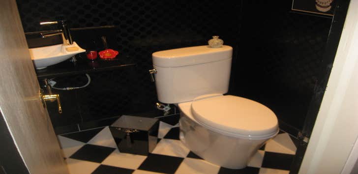 Bathroom remodel Tore out the old pink sink and floor and replace it in black and white tile with a free standing black granite shelf and white vessel.