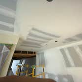 Photos by Interior Art Drywall Inc #1 Hang the walls on ceiling and walls . I just let the open on ceiling where plumbers were pending to fix the pipes