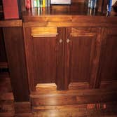 Walnut room Office/Husbands retreat. Features Solid walnut lower cabinet, with upper open shelf cabinets with glass shelves and lighting in upper cabi